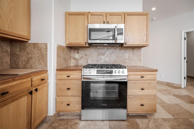 1921 Walton Creek Rd Unit 4, Steamboat Springs, CO 80487 - kitchen with appliances with stainless steel finishes, light brown cabinets, decorative backsplash, light countertops, and recessed lighting