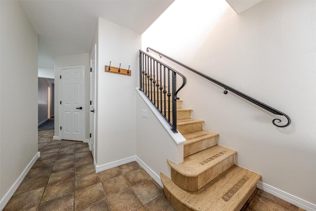 1921 Walton Creek Rd Unit 4, Steamboat Springs, CO 80487 - stairway featuring baseboards and stone finish flooring