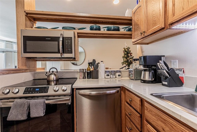 1920 Ski Time Square Dr Unit 315, Steamboat Springs, CO 80487 - kitchen featuring appliances with stainless steel finishes, brown cabinetry, light countertops, and a sink