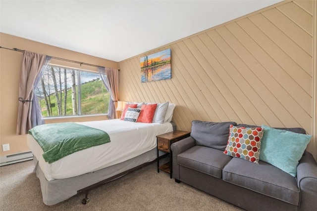 carpeted bedroom with a baseboard heating unit and wood walls