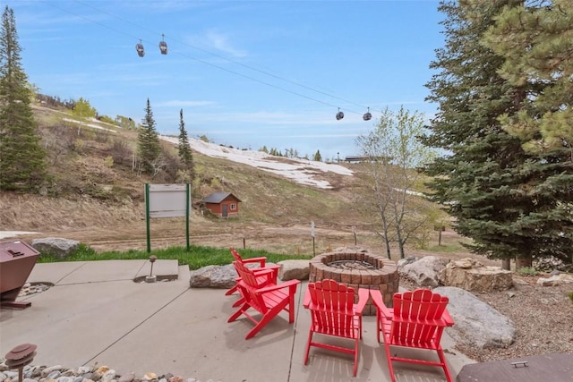 view of patio / terrace with an outdoor fire pit