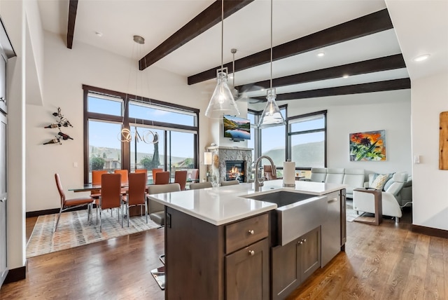 14 E Baron Way, Silverthorne, CO 80498 - kitchen featuring open floor plan, a sink, a fireplace, light countertops, and beam ceiling