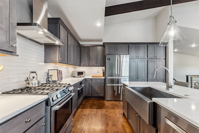 14 E Baron Way, Silverthorne, CO 80498 - kitchen with stainless steel appliances, wall chimney exhaust hood, a sink, dark wood-style flooring, and decorative backsplash