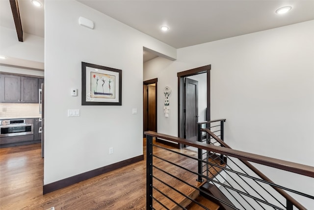 14 E Baron Way, Silverthorne, CO 80498 - hallway featuring an upstairs landing, light wood-style flooring, recessed lighting, beam ceiling, and baseboards