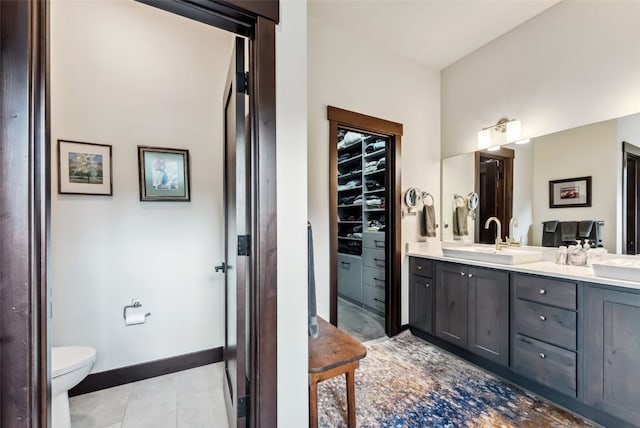 14 E Baron Way, Silverthorne, CO 80498 - bathroom with double vanity, tile patterned floors, toilet, and baseboards