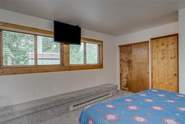 bedroom featuring a baseboard heating unit and carpet floors