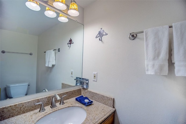 bathroom with toilet and vanity