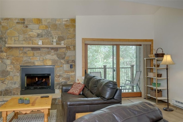living room with a baseboard radiator, a stone fireplace, lofted ceiling, and wood finished floors