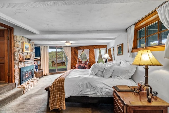 27845 County Road 41a, Steamboat Springs, CO 80487 - carpeted bedroom featuring access to outside, a fireplace, and beam ceiling