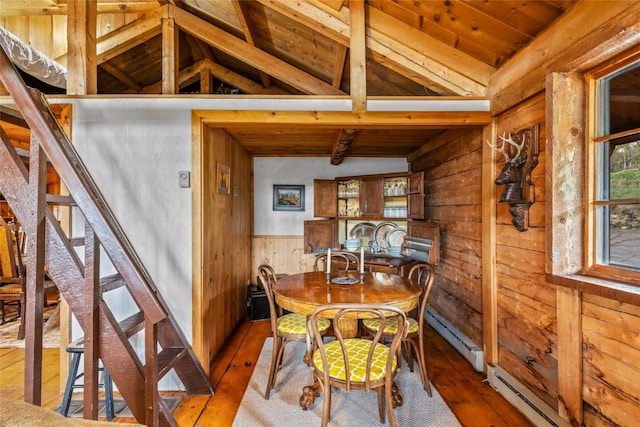 27845 County Road 41a, Steamboat Springs, CO 80487 - dining space featuring wood walls, wood ceiling, hardwood / wood-style flooring, baseboard heating, and a baseboard radiator
