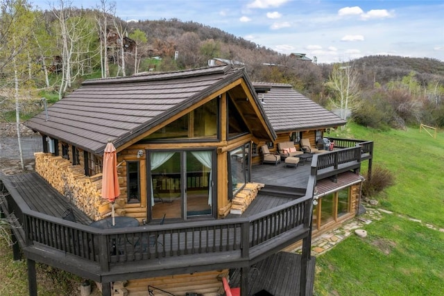 27845 County Road 41a, Steamboat Springs, CO 80487 - back of property featuring a deck with mountain view, a lawn, outdoor lounge area, and a view of trees