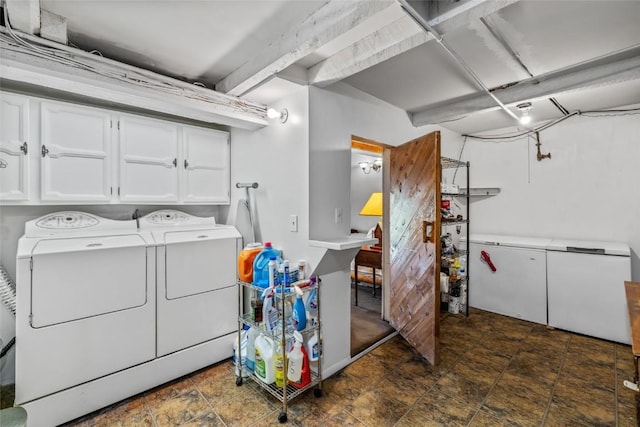 27845 County Road 41a, Steamboat Springs, CO 80487 - clothes washing area featuring cabinet space, washing machine and clothes dryer, and stone finish flooring
