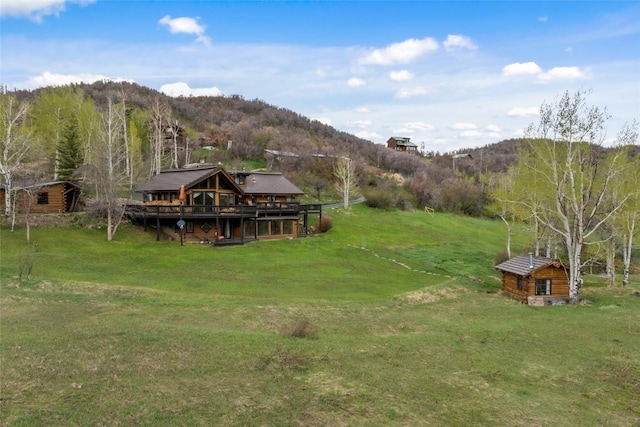 27845 County Road 41a, Steamboat Springs, CO 80487 - view of green lawn featuring an outbuilding, a rural view, and a deck with mountain view