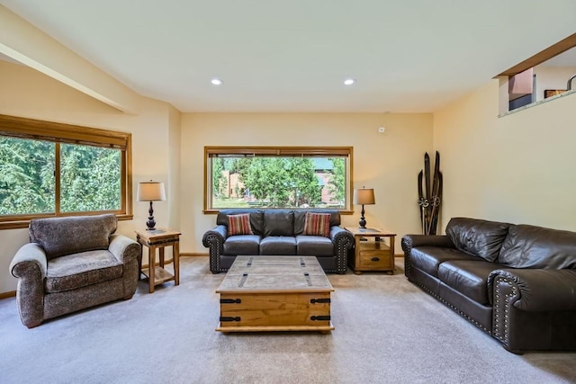 carpeted living area with baseboards and recessed lighting