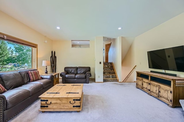 carpeted living area featuring stairs and recessed lighting