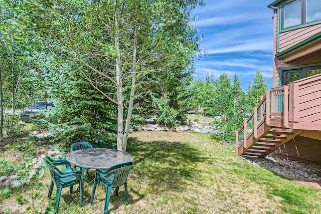 view of yard with stairway and a wooden deck