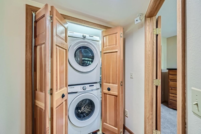 clothes washing area with laundry area and stacked washer / dryer
