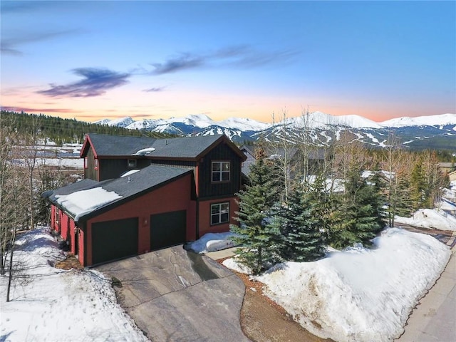 186 Rachel Ln, Breckenridge, CO 80424 - chalet / cabin featuring an attached garage, a shingled roof, driveway, and a mountain view