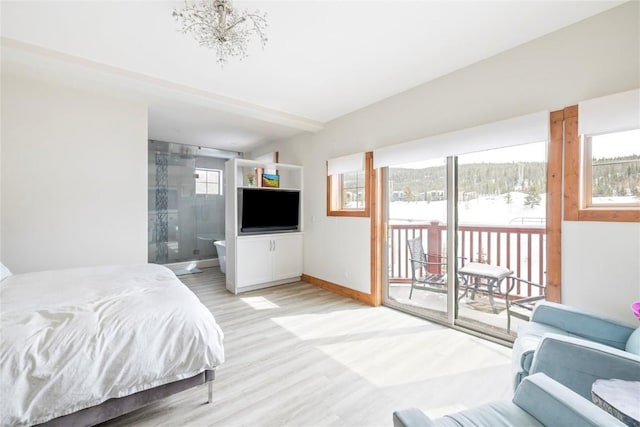 186 Rachel Ln, Breckenridge, CO 80424 - bedroom featuring access to exterior, ensuite bathroom, baseboards, an inviting chandelier, and light wood-style floors