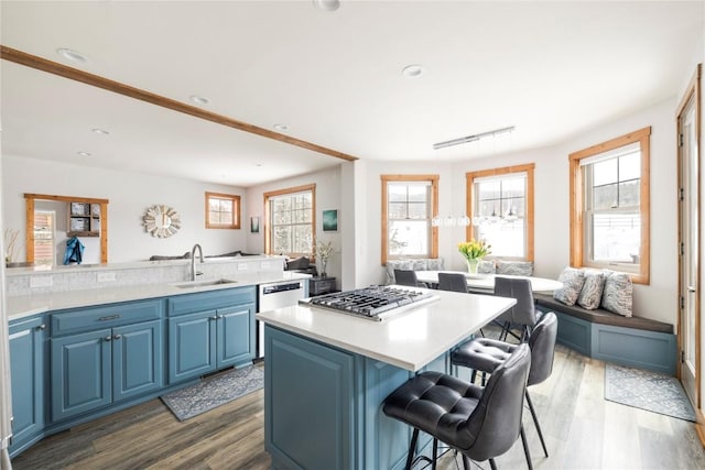 186 Rachel Ln, Breckenridge, CO 80424 - kitchen with a kitchen breakfast bar, a sink, a healthy amount of sunlight, wood finished floors, and blue cabinetry