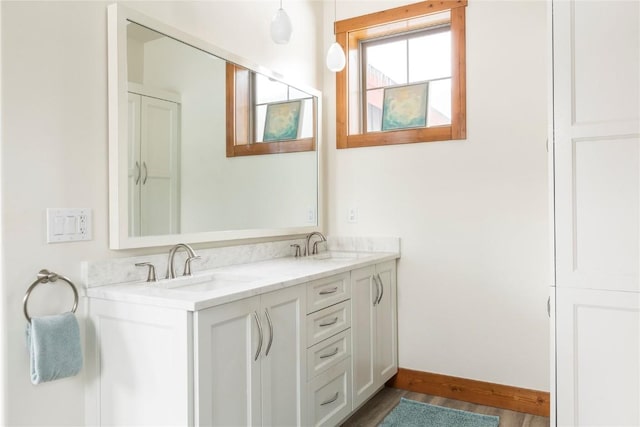186 Rachel Ln, Breckenridge, CO 80424 - bathroom with double vanity, baseboards, wood finished floors, and a sink