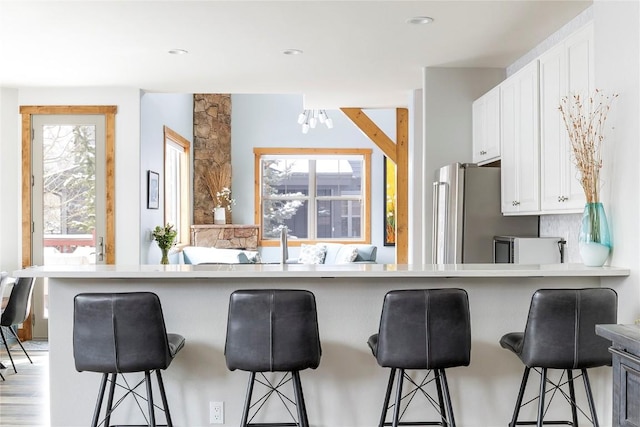 186 Rachel Ln, Breckenridge, CO 80424 - kitchen featuring white cabinets, a healthy amount of sunlight, a chandelier, and a breakfast bar area