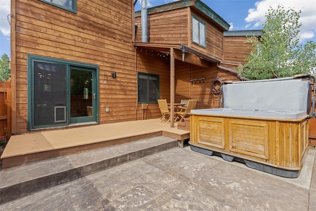 329 N Chipmunk Cir, Silverthorne, CO 80498 - rear view of property with a hot tub, a patio area, and outdoor dining space