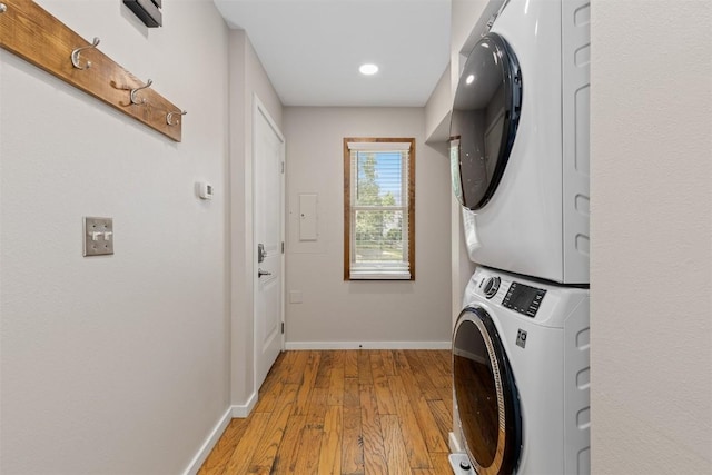 329 N Chipmunk Cir, Silverthorne, CO 80498 - laundry room featuring stacked washer and clothes dryer, light wood-type flooring, and recessed lighting