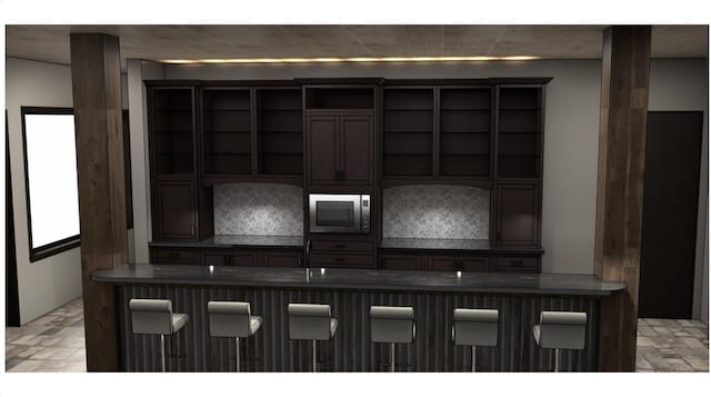 kitchen featuring a breakfast bar and built in microwave