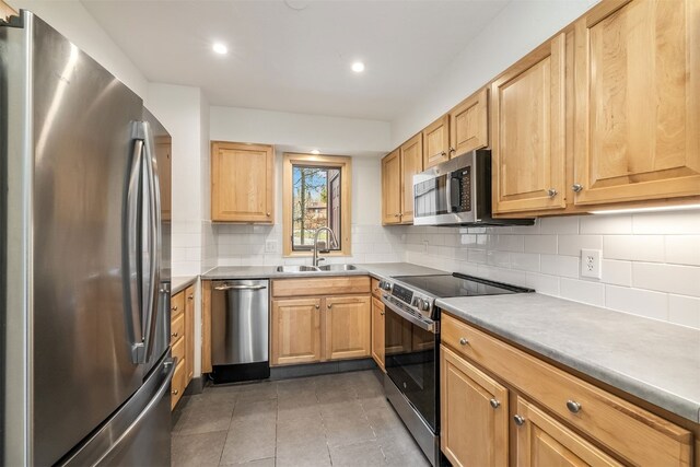 21 Buffalo Dr Unit 28, Silverthorne, CO 80498 - kitchen featuring stainless steel appliances, a sink, backsplash, recessed lighting, and tile patterned floors