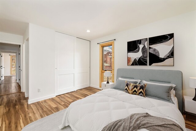 21 Buffalo Dr Unit 28, Silverthorne, CO 80498 - bedroom with wood finished floors, baseboards, a closet, and recessed lighting