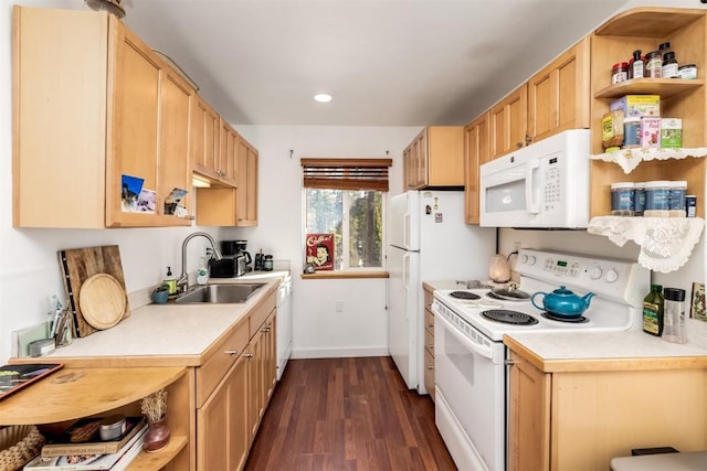 kitchen featuring dark wood-style flooring, a sink, white appliances, light countertops, and baseboards