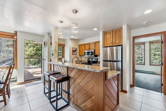 175 Argentine Ct Unit 1513, Keystone, CO 80435 - kitchen with appliances with stainless steel finishes, baseboard heating, light stone counters, light tile patterned floors, and recessed lighting