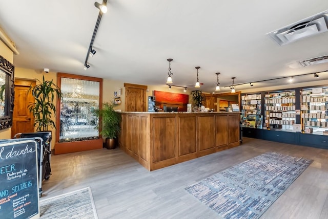 175 Argentine Ct Unit 1513, Keystone, CO 80435 - kitchen with track lighting, brown cabinets, light wood-style flooring, and decorative light fixtures