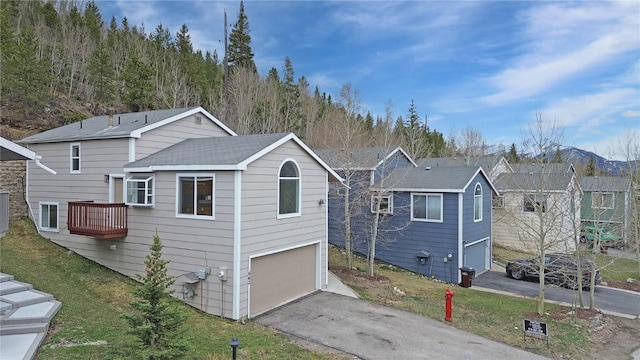 662 Alpine Rd, Dillon, CO 80435 - view of side of home with a garage, asphalt driveway, and a lawn