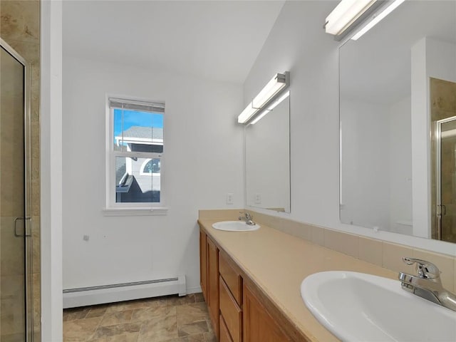 662 Alpine Rd, Dillon, CO 80435 - bathroom with baseboard heating, a shower stall, double vanity, and stone finish flooring
