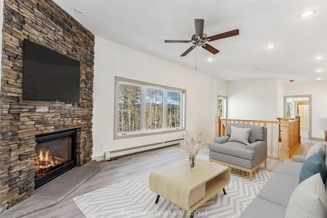 0630 Temple Trl, Frisco, CO 80443 - living area with recessed lighting, wood finished floors, a baseboard heating unit, a fireplace, and ceiling fan