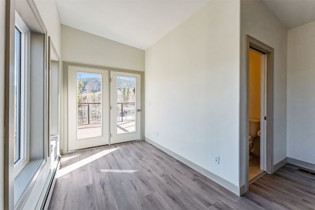 0630 Temple Trl, Frisco, CO 80443 - spare room featuring a baseboard heating unit, baseboards, wood finished floors, and visible vents