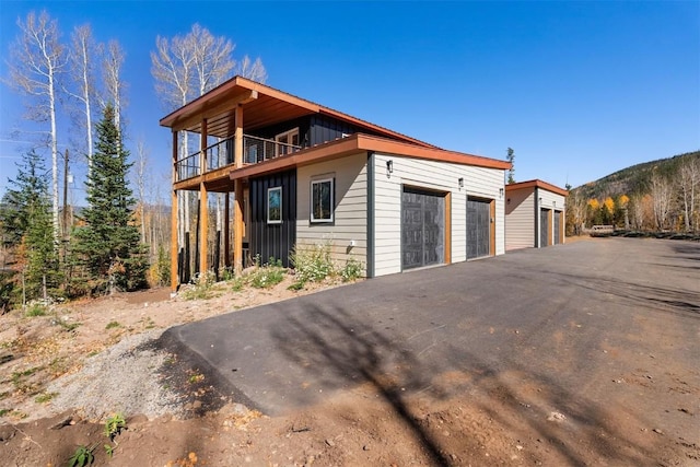 0630 Temple Trl, Frisco, CO 80443 - exterior space with a detached garage, a balcony, and board and batten siding