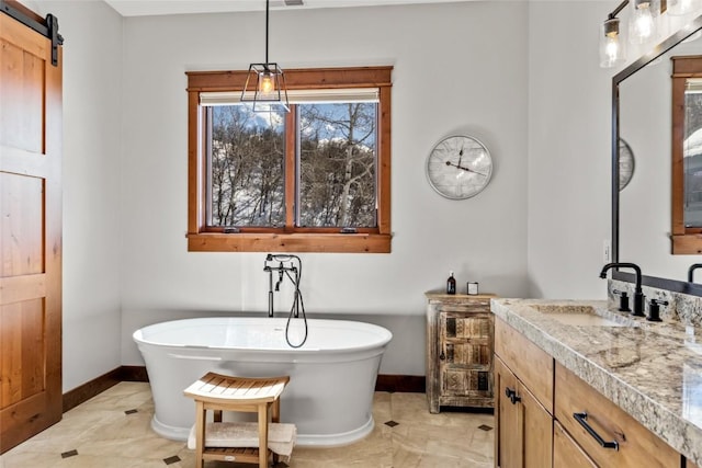 2357 Poma Ln Lot 2, Steamboat Springs, CO 80487 - bathroom with baseboards, vanity, a freestanding bath, and marble finish floors
