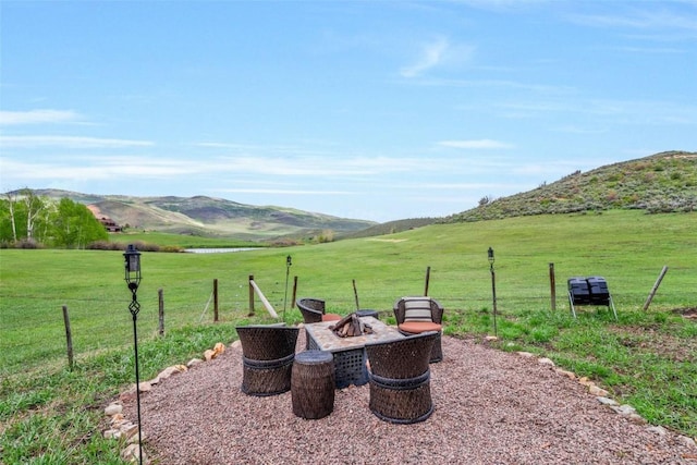 29780 Riffle Run, Oak Creek, CO 80467 - view of patio / terrace featuring an outdoor fire pit, a mountain view, and a rural view
