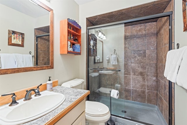full bath featuring vanity, toilet, and a stall shower