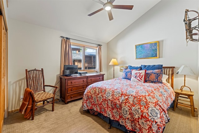 bedroom with vaulted ceiling, a ceiling fan, and light colored carpet