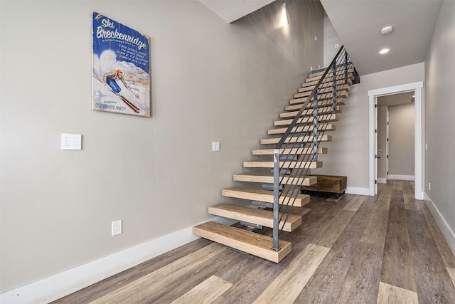 stairway featuring baseboards, recessed lighting, and wood finished floors