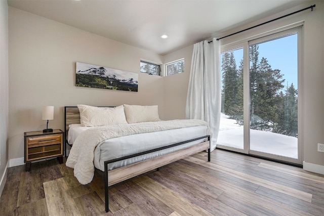 bedroom with baseboards, access to outside, recessed lighting, and wood finished floors