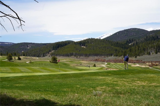 203 Gentian Rd, Keystone, CO 80435 - view of community featuring a mountain view, view of golf course, a yard, and a wooded view