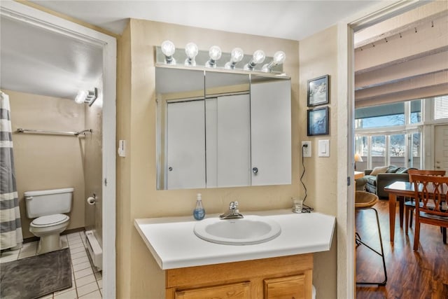 bathroom with vanity, tile patterned flooring, and toilet