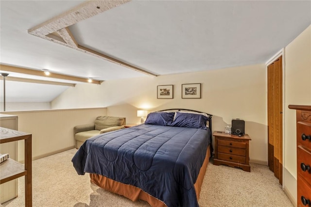 bedroom featuring carpet, beam ceiling, and baseboards