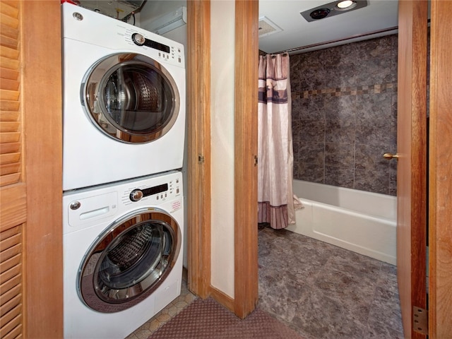 washroom featuring stacked washer and dryer