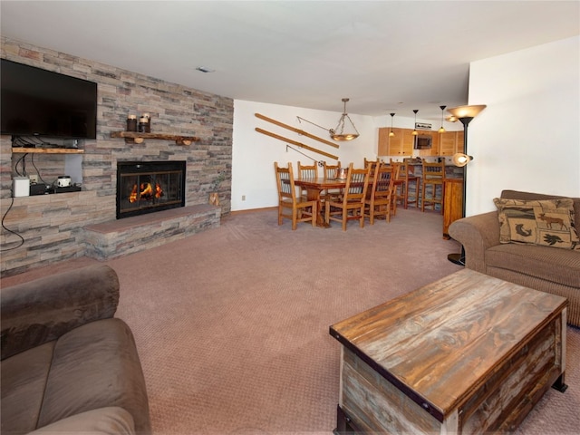 living room featuring a fireplace and carpet floors